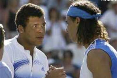 Nadal holds off Tsonga, Federer eases through