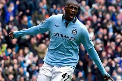 Toure, Tevez keep alive Man City's title hopes