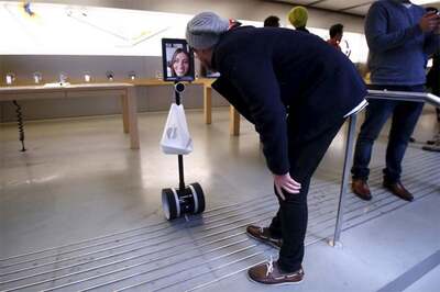 Woman sends 'iPad robot' to queue for new Apple iPhone